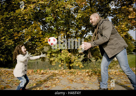 Father and daughter is playing with ball Stock Photo