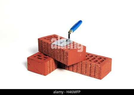 Red bricks, trowel, stones, red, stacked, about one another, on each other, transfers, build, based, construction financing, building society savings agreement, work, spatula, tennis racket, craft, Stock Photo