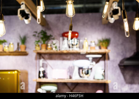 Incandescent light bulbs in a loft style room interior with furniture Stock Photo