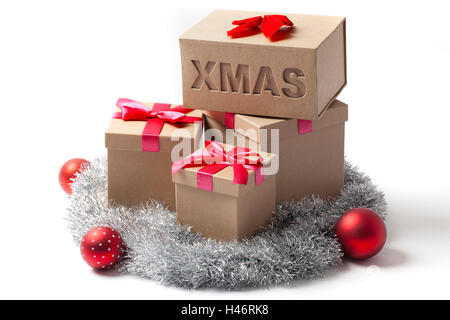 Several gift boxes Christmas tree balls and tinsel garland isolated on white. Stock Photo