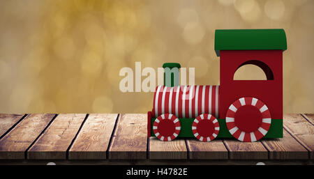 Composite image of steam engine toy model with striped Stock Photo
