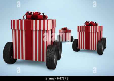 Composite image of striped red and white gift box on wheels Stock Photo