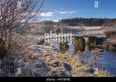 Frosty landscape surrounding the ancient clapper bridge at Postbridge in Dartmoor National Park, Devon, England. Winter (Decembe Stock Photo