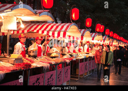 China, Peking, Wangfujing, Dong'anmen, Daijie, done cuisine night market, snack stalls, passers-by, evening, Asia, town, city, business centre, in Chinese, sales, street sales, street snack, snack, market, sales booths, foods, snacks, Asian, cooking cuisine, night market, offer, choice, illuminateds, lined up, side by side, specialities, Food, delicatessen, people, dusk, outside, Stock Photo