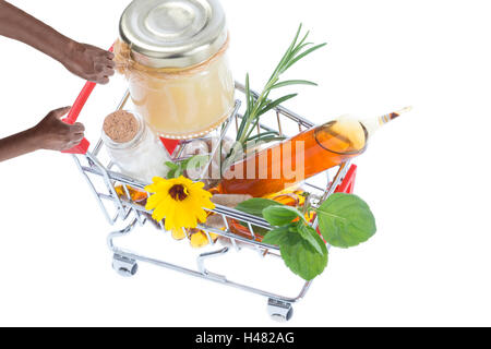 Hands pushing supermarket trolleys filled with pills Stock Photo