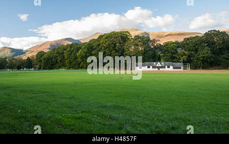 Fitz Park,Keswick showing the cricket pavillion and field with the imposing Skiddaw in the background Stock Photo