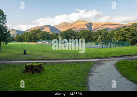 Fitz Park,Keswick showing the cricket pavillion and play areas with the imposing Skiddaw in the background Stock Photo