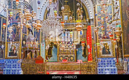 The prayer hall of St James Cathedral with the beautiful altar, medieval icons and the oil lamps, Jerusalem Israel Stock Photo