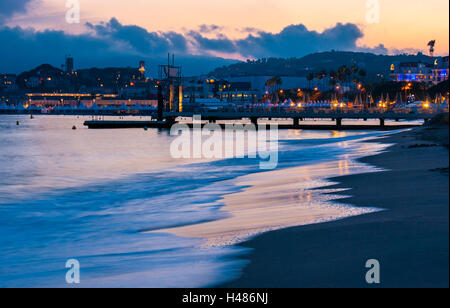 The sea in the evening illuminates by citylights, Cannes, France.