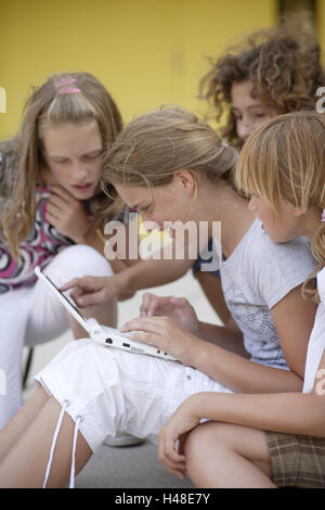 Girls, laptop, playground, chat, communication, gesture, laugh, Stock Photo