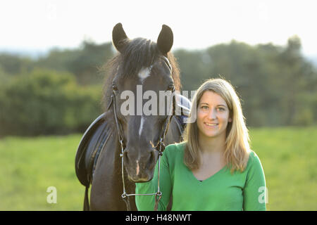 Teenage girl, horse, Arabo-Haflinger, meadow, head-on, stand, view camera, Stock Photo