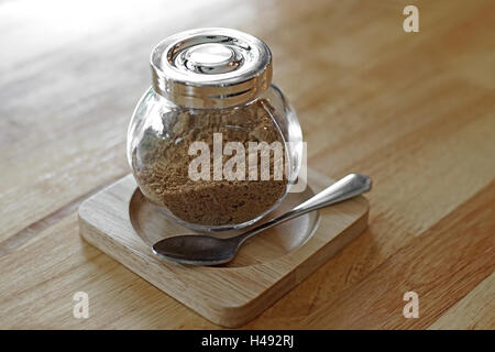jar of brown sugar and spoon on wooden table Stock Photo
