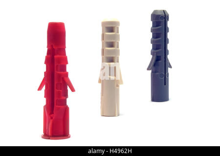 Plastic wall dowel plugs, isolated macro closeup, red, ivory white, gray, grey Stock Photo