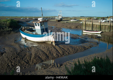 Brancaster Staithe on the North Norfolk Coast, England  boats on mudflats at Low tide. Stock Photo