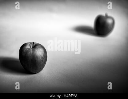 Apples one in focus the other out of focus arranged on a white background. Showing the shape, form and texture of the fruit b&w. Stock Photo