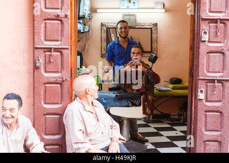 Friendly people in barber shop on the streets of Marrakesh, Morocco Stock Photo
