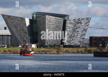 The Titanic Building  in Belfast's Titanic Quarter.In the foreground is the 'Mona', a boat used for Titanic Boat Tours. Stock Photo