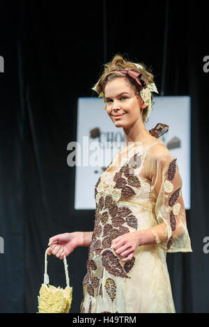 Kensington Olympia, London, 13th October 2016. A model presents a couture outfit inspired by chocolate at the Chocolate Fashion Show. The Chocolate show, the grand finale of Chocolate Week, opens at London's Olympia with a VIP gala evening and chocolate fashion show, before welcoming visitors from 14th-16th October. Credit:  Imageplotter News and Sports/Alamy Live News Stock Photo