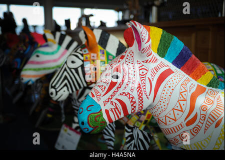 Brightly coloured hand decorated and painted life-sized zebra sculptures of on display in Southampton, England. The 197 model zebras were exhibited at an event called Marwell's Zany Zebras and were later auctioned to raise funds for Marwell Wildlife's conservation work. Local schools, artists and groups helped to paint each zebra. Stock Photo