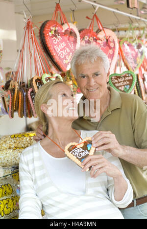Fair, Senior couple, happy, gingerbread heart, label 'Trust you', half portrait, person, couple, senior citizens, partnership, respect, happy, amusements, leisure time, outside, sweet state, sales, hearts, sweetly, sweet, joy life, embassy, request, courage, words, positively, Stock Photo