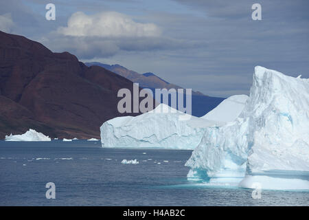 Iceberg, red mountain in the background, mountain, Clearing fjord, Scoresbysund, Greenland, Stock Photo
