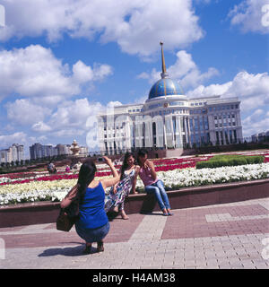 Kazakhstan, Astana, Ak Orda presidential palace, tourist, structure, building, place of interest, person, women, take of a photo, government building, presidential palace, flowers, pink, white, outside, Stock Photo