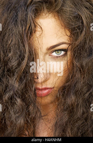Young red-haired woman with curly hair looking at camera, Stock Photo