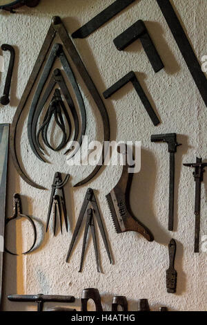 Old carpentry tools hanging on a wall Stock Photo