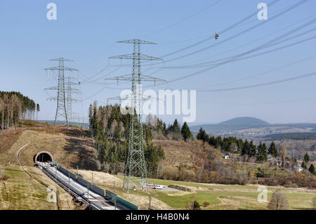 Man working on high voltage power lines, gondola, Thuringian Forest Stock Photo