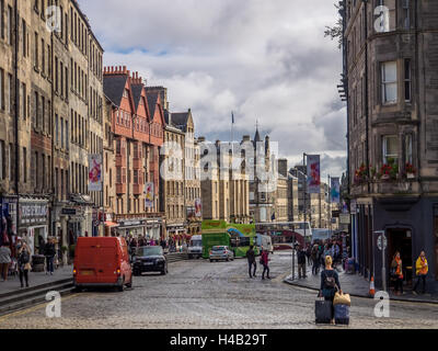 Edinburgh, Scotland -  02 September 2016 : Woman pulling luggage suitcases and tourists on the street in the Edinburgh Old Town Stock Photo