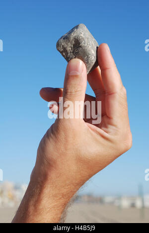 Hand, stone, showing, holding up, man's hand, man, finger, male, beach, finding, thumb, forefinger, holding, looking, found, discovery, throwing, throwing stone, choice, selecting, sorting, esteeming, nature, outdoors, parts of the body, close-up, detail, Stock Photo