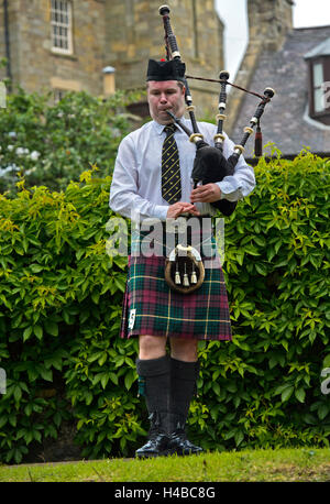 Solo bagpiper playing bagpipes in kilt, Bagpiper Music Competition, Ceres Highland Games, Ceres, Scotland, United Kingdom Stock Photo