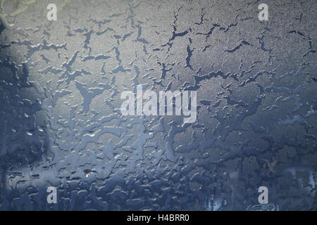 blue glass surface covering patterns from ice flower, cracks, snowflakes,drops painted winter Stock Photo