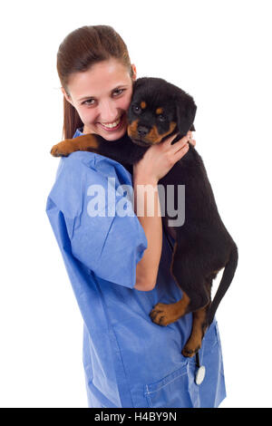 Brunette veterinary with a rottweiler puppy dog isolated on white background Stock Photo