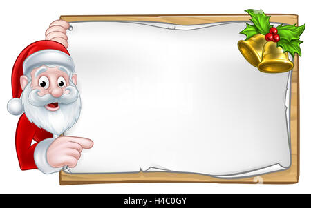 Santa cartoon Christmas character peeking around a wooden scroll sign with gold bells and holly Stock Photo