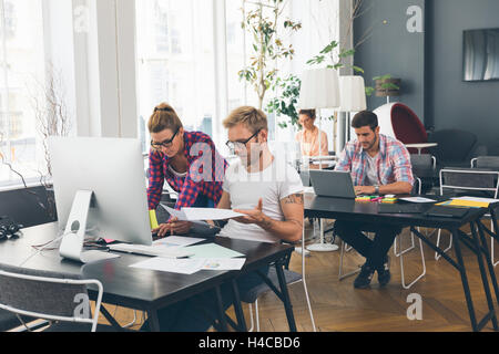Young business people working at office on new project Stock Photo