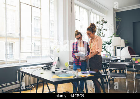 Two women working together in office Stock Photo