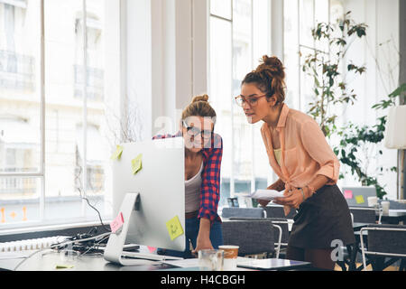 Two women working together in office Stock Photo
