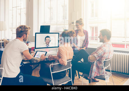 Coworkers doing a video conference in the conference room Stock Photo