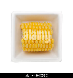 Corn cob in a square bowl isolated on white background Stock Photo