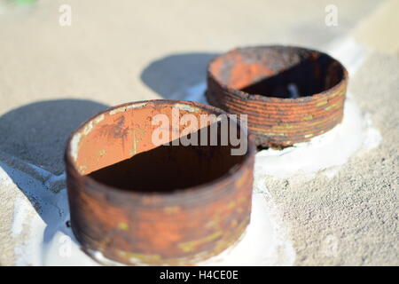 Rusty Weathered Drain Pipes in Concrete with a Shadow Stock Photo