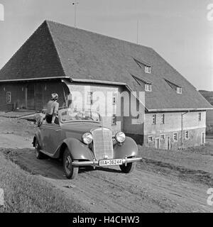 Zwei Männer und eine Frau in einem Mercedes Benz 170 V (W 136) vor dem Furtwänglerhof im Schwarzwald, Deutschland 1930er Jahre. Two men and a woman in a Mercedes Benz 170 V (W 136) in front of Furtwaengler grange in Black Forest, Germany 1930s. Stock Photo