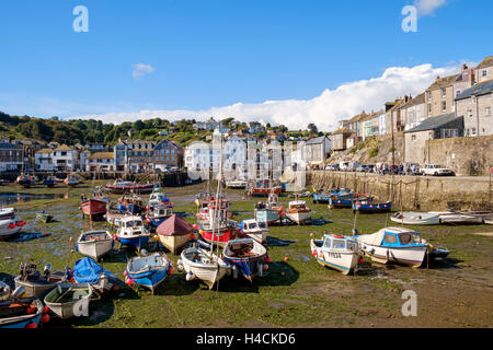 Mevagissey harbour & fishing port with fishing boats at low tide, Cornwall, England, UK Stock Photo