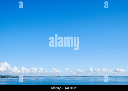 Cumulus clouds forming over a coastline on the horizon, UK Stock Photo