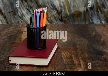 Book and School Stationery in holder - Education Concept. Stock Photo