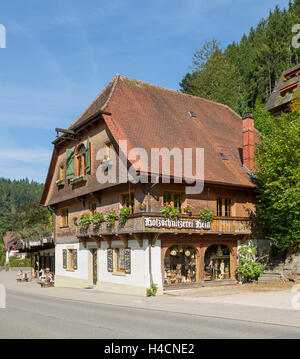 Germany, Baden-Wurttemberg, mountain Tri, wooden carving Hein, typical Black Forest house with hipped roof, shop-window, exhibit carvings, an old traditional craft in the Black Forest, Stock Photo