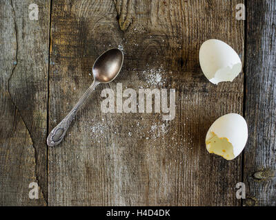 egg shells from eaten boiled eggs on old wooden weathering table Stock Photo