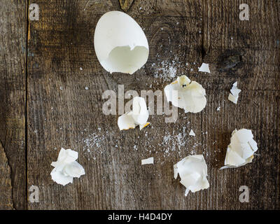 egg shells from eaten boiled eggs on old wooden weathering table Stock Photo