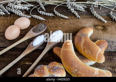 Roll, pastry from home bakery on wood table with wheat Stock Photo