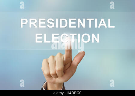 business hand pushing presidential election button on blurred background Stock Photo